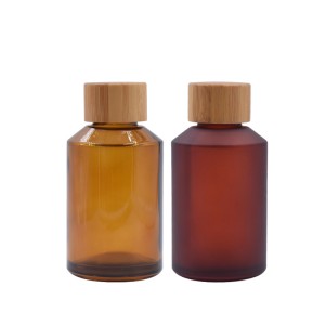 cosmetic amber glass bottle with bamboo cap